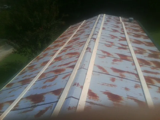 Rusted metal roof panels with new wood purlins before replacement — Storm Damage Roof Repair in Victorville by Roofing Brothers