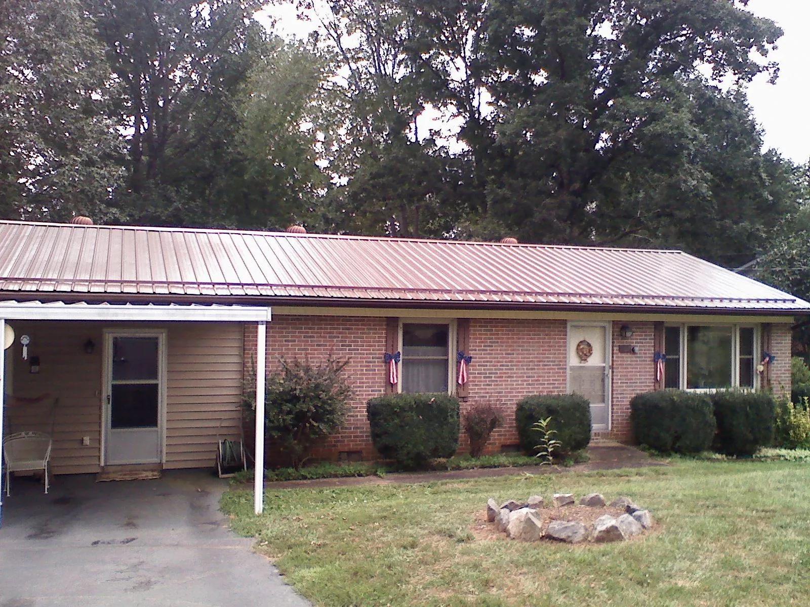 Bronze metal roof and carport on a brick ranch home — Roof Repair work by our crew in Victorville
